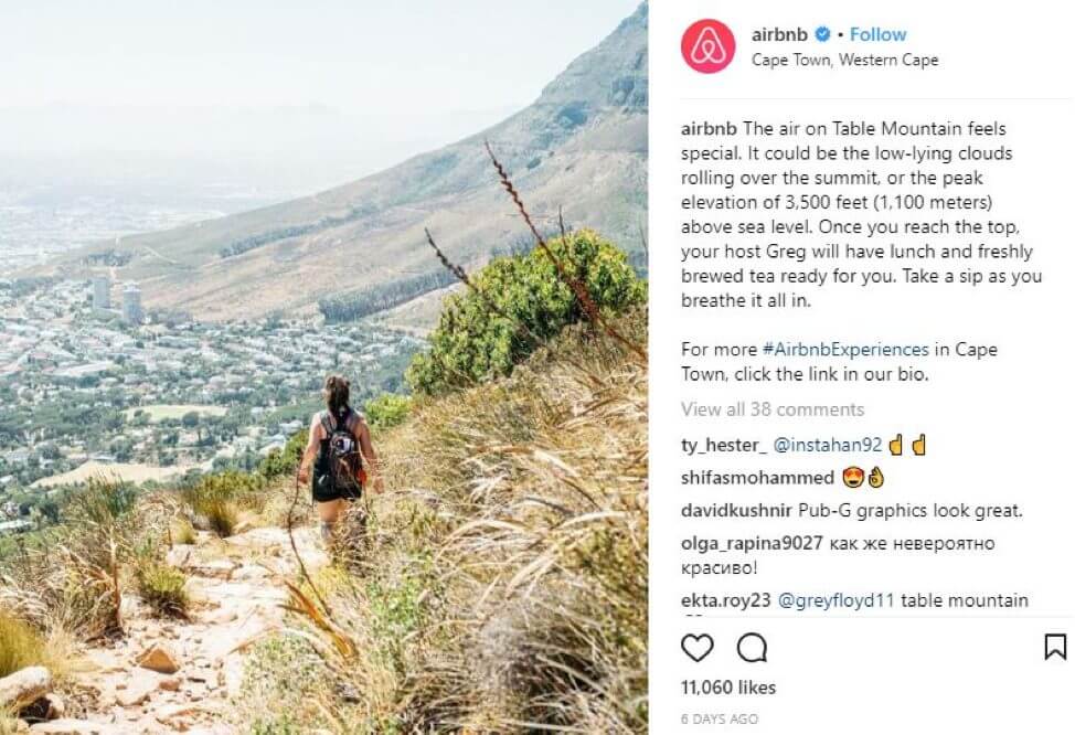 Instagram post of woman hiking on hillside above town