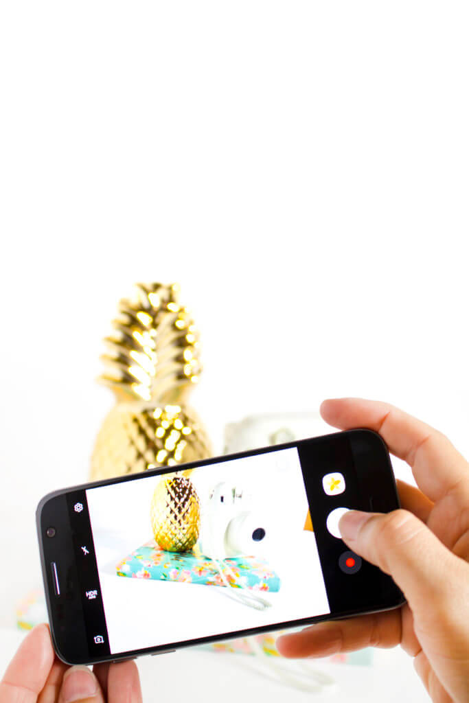 How to take product photos with your smartphone - iphone taking product photo of gold pineapple and white camera