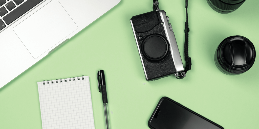 how to get sponsored on instagram header image - camera and computer on green flat lay