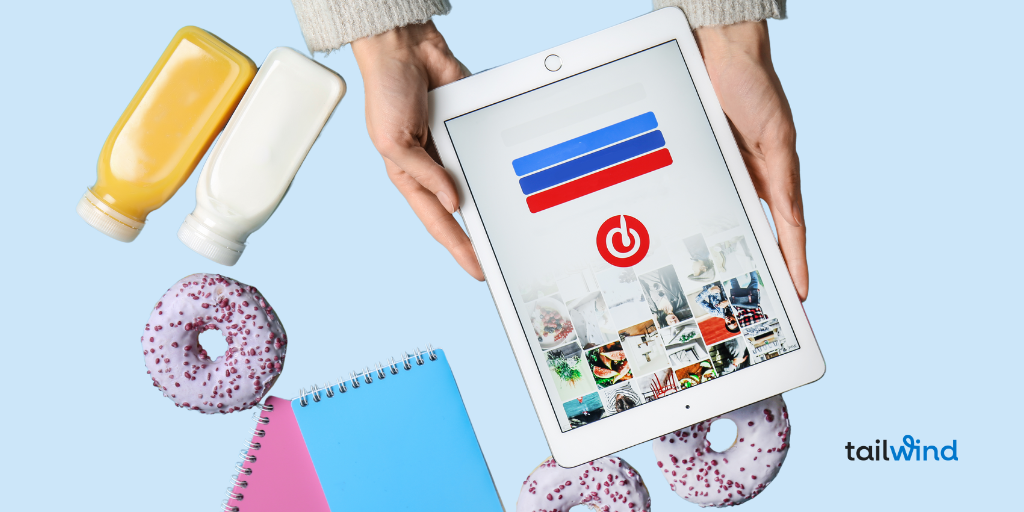 Hands hold a tablet displaying a social media app, surrounded by colorful donuts, juice bottles, and notebooks on a light blue background. Tailwind logo visible.