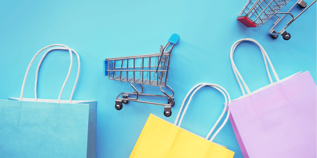 Instagram Support Small Business Sticker header image - miniature shopping carts and shopping bags on blue background