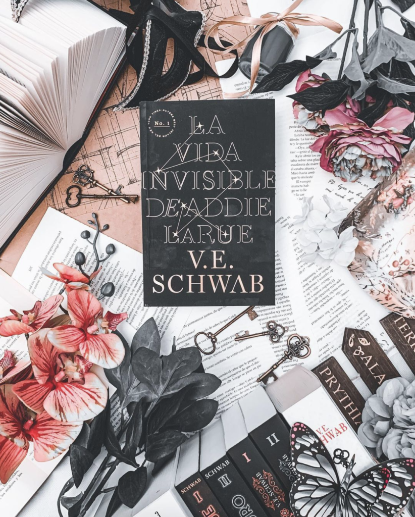 flatlay photo of book surrounded by paper and keys
