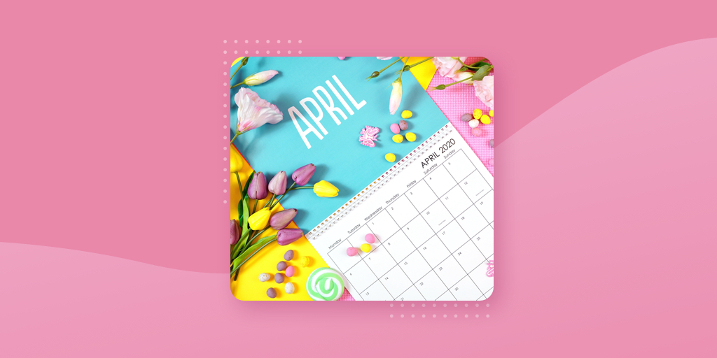 An April calendar surrounded by tulips on a pink background