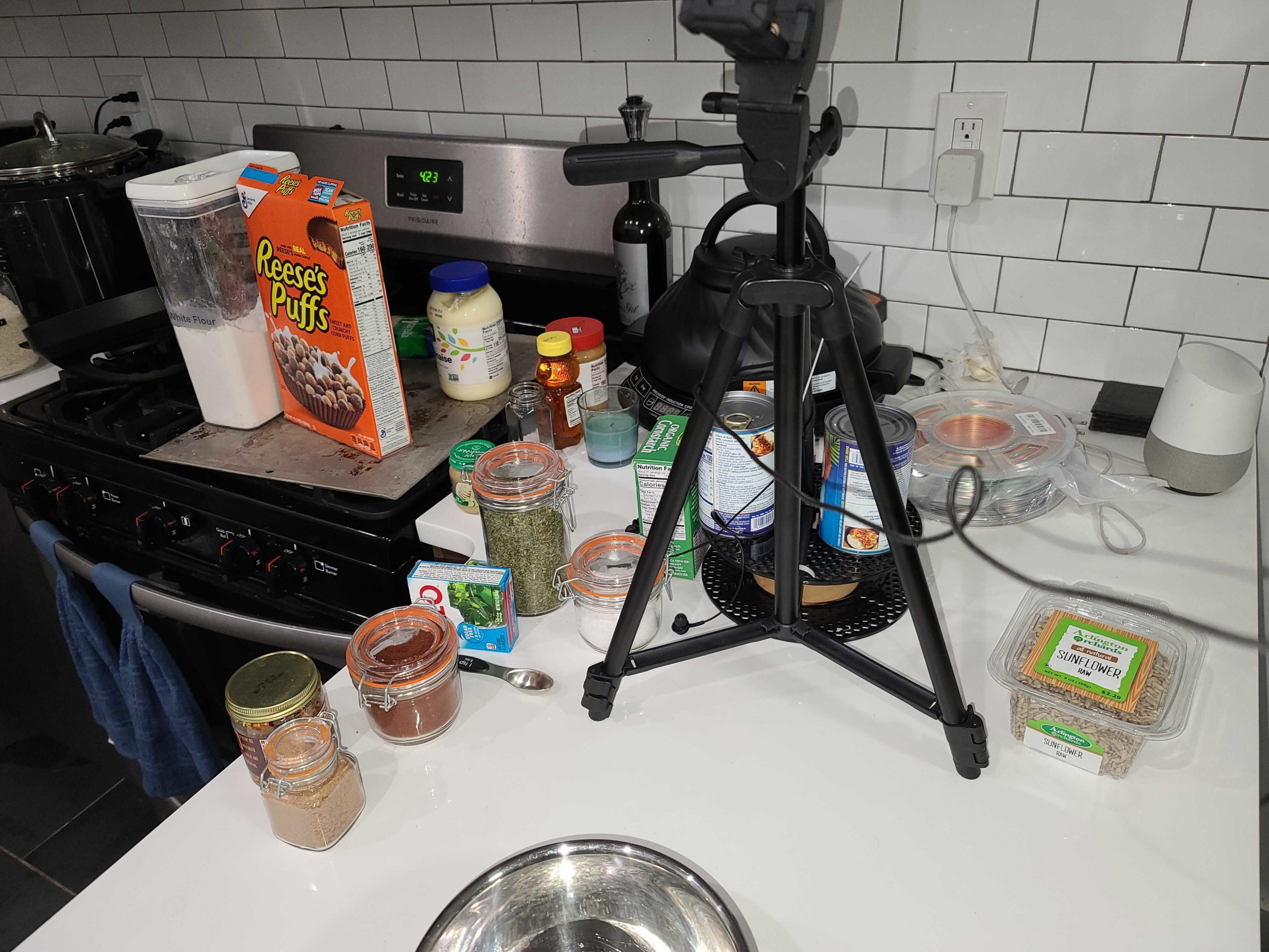 Photo of Alex's kitchen set up for recording of the Filthtopus recipe. White tile backsplash, various ingredients strewn about.