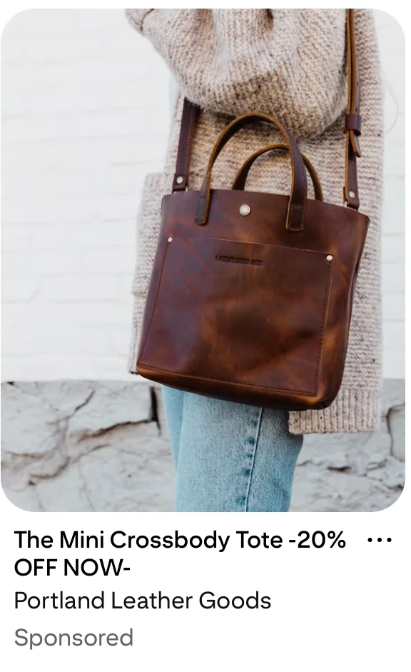 A Pinterest Pin of a person in a cozy beige sweater and jeans carries a dark brown leather crossbody tote bag with handles against a light brick wall.